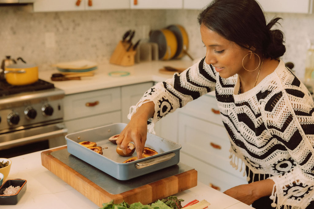 Divya preparing baked peaches in the kitchen
